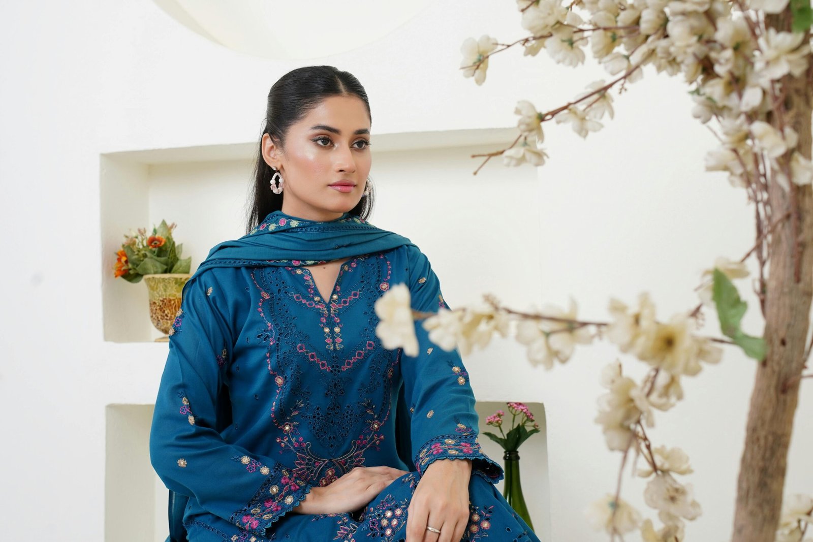 Stunning portrait of a woman in traditional blue dress, showcasing elegance and style.